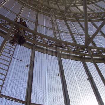 Mobile interior hangladder with integrated lineline used for window cleaning of a vertical facade. Mobile interior hangladder with integrated lineline - Building Maintenance Unit